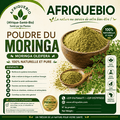 Poudre de Moringa oleifera de la marque AFRIQUEBIO, riche en vitamines, dans un emballage blanc avec étiquette verte.